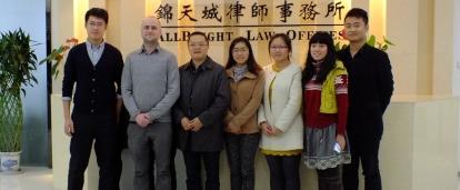 Projects Abroad Business Interns pose for a photo in a Law Office during a Business Internship in China. A group of Business Interns pose for a group photo infront of a reception desk at a law office in China.